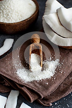 Coconut flour in a wooden spoon close up