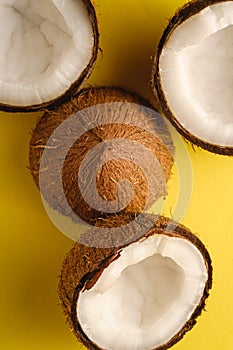 Coconut fruits on yellow plain background, abstract food tropical concept