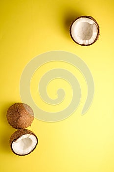 Coconut fruits on yellow plain background, abstract food tropical concept