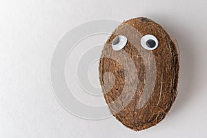 Coconut with Googly eyes and funny face. Crazy nut concept