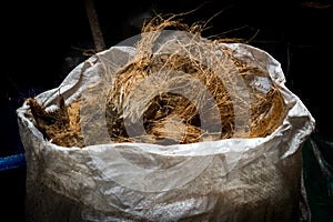 Coconut husk placed on a white sack photo