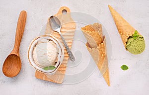 Coconut ice cream flavours in half of coconut setup on white stone background. Summer and Sweet menu concept