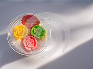 Coconut jelly sweet dessert with colorful rose shape in cup with happy birthday message