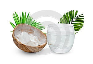 Coconut juice in glass cup with green leaves pattern isolated on white background