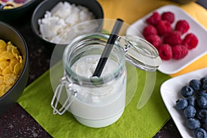 Coconut milk with coconut flakes in a mason jar with a straw