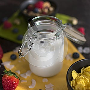 Coconut milk in a mason jar with a straw. in close-up