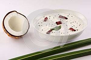 Coconut and Mint chutney served with coconut leaves and raw coconut.