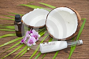 Coconut oil in bottles with fresh coconuts