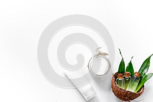 Coconut oil and cream on white background top view copyspace