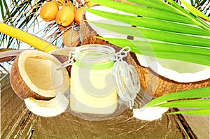 Coconut oil with cut coconut and leaves