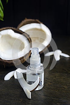 Coconut oil for the face. Cosmetic product in a bottle with a dispenser