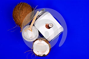 coconut oil and fresh coconuts, on a blue background