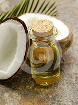 Coconut oil in a glass bottle and nuts