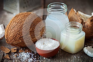 Coconut oil and milk, grounded coconut flakes and coco nut photo