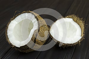 Coconut pulp fresh tropical brown white organic coconut milk on wooden black background