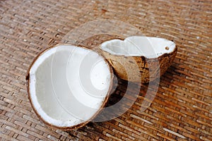 Coconut with shell on bamboo weave background