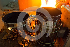 coconut shells being flamed to use in a beekeeping smoker