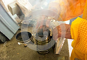 coconut shells being used in a smoker at an apiary in the caribbean