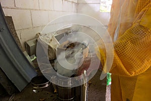 coconut shells being used in a smoker at an apiary in the caribbean