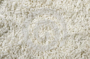 Coconut shreds background. Natural seasoning texture. Natural spices and food ingredients