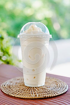 Coconut smoothie on wooden table