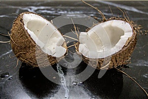 coconut split in half on a kitchen countertop