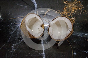 coconut split in half on a kitchen countertop