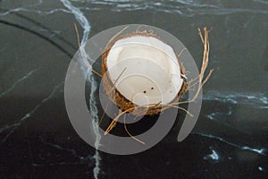 coconut split in half on a kitchen countertop