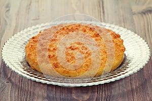 Coconut tarte on dish on brown background