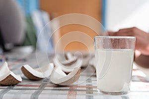 Coconut water and fresh pieces coconut on the table. Exotic food form Dominican Republic