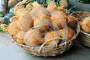 Coconuts in the basket in vegetable shop