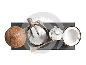 Coconuts, coconut milk and grated coconut on white background.. Top view