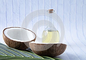 Coconuts and Coconut oil product organic for cosmetic natural care health in a bottle put on a white table