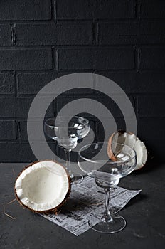 Coconuts with orhid flowers, on dark background. Copy space.