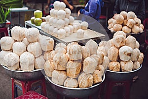 Coconuts in the Vietnamese market, typical street food business in Asia