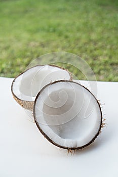 Coconuts on the white isolated over blurred grass background