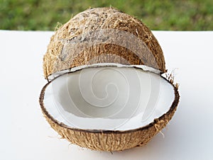 Coconuts on the white isolated over blurred grass background