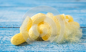 Cocoon , Silk on Blue wooden.