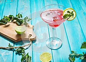 Coctail margarita with lime on blue wood background