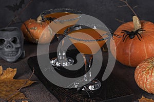 Coctail Pumpkintini of pumpkin and martini with black sugar rim for Halloween parties or Thanksgiving Day