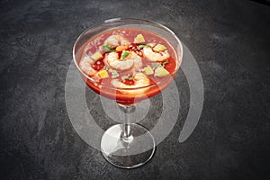 Coctel de gambas, Mexican shrimp cocktail with avocado, on a dark background photo
