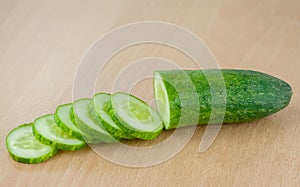 Cocumber slices and half on wood table