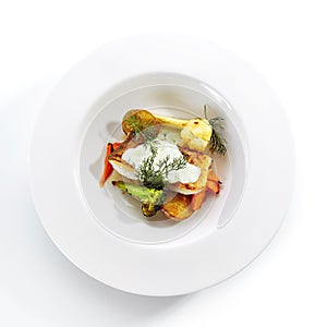 Cod Fillet with Baked Vegetables on White Restaurant Plate Isolated
