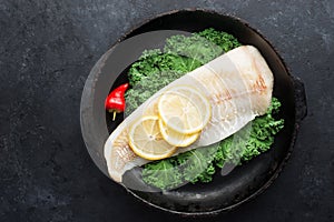 Cod fillet of sea white fish, kale, hot peppers, ingredients of healthy balanced comfortable nutrition. Protein and