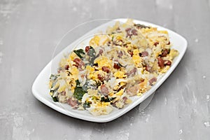 cod fish with corn bread, spinach and beans on dish