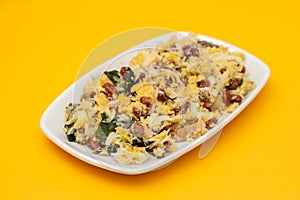 cod fish with corn bread, spinach and beans on dish