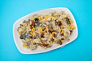 cod fish with corn bread, spinach and beans on dish