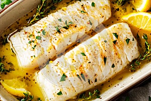 Cod fish fillets with lemon and thyme. Selective focus
