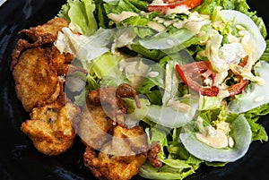 cod fritters accras de morue, with tomatoes and salad
