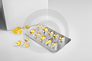 Cod liver oil capsules on white background